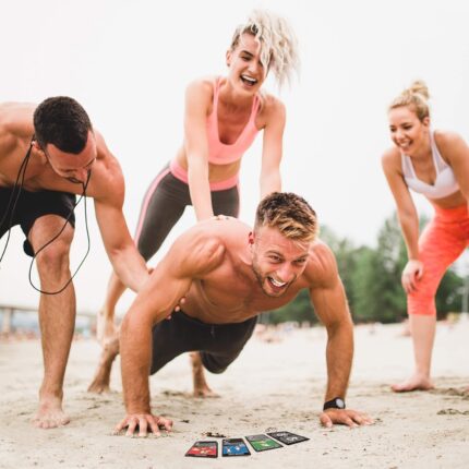 "Friends laughing while doing a Stack 52 workout on the beach"